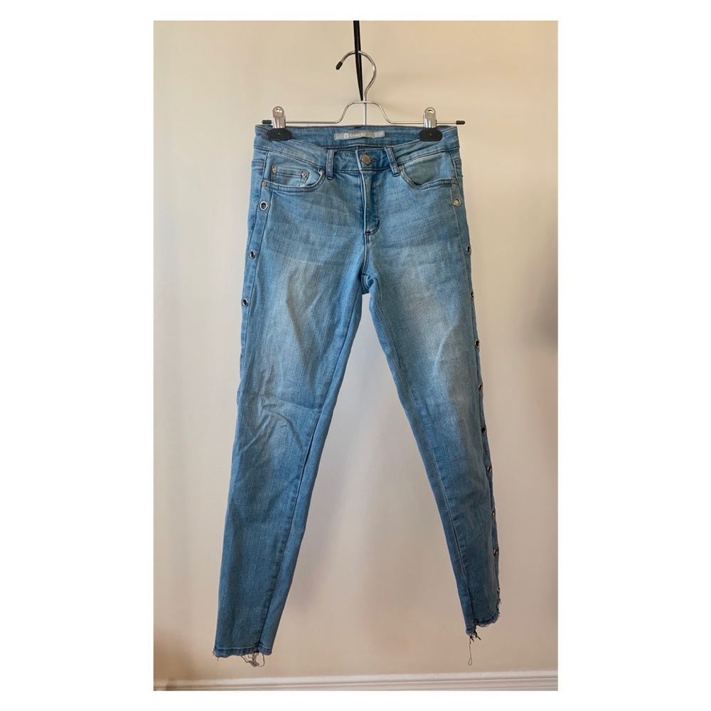 Blue skinny jeans with eyelet cutouts on sideseams